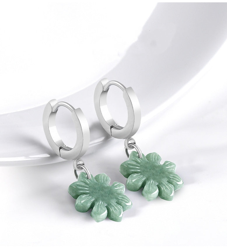 Green jade sunflower earrings displayed on white with carved petal details visible