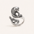 Antique silver koi fish adjustable ring standing on a warm white background
