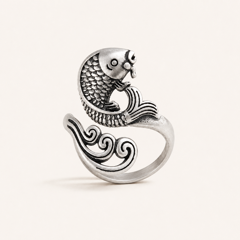 Antique silver koi fish adjustable ring standing on a warm white background