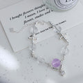 Amethyst and white crystal star bracelet on a soft gray background