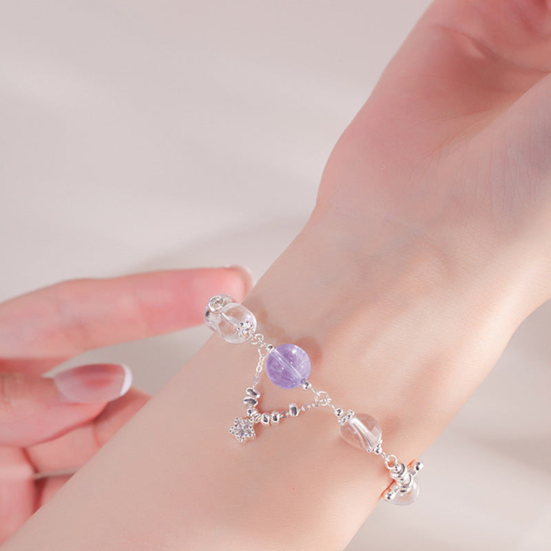 Woman wearing amethyst and white crystal star bracelet
