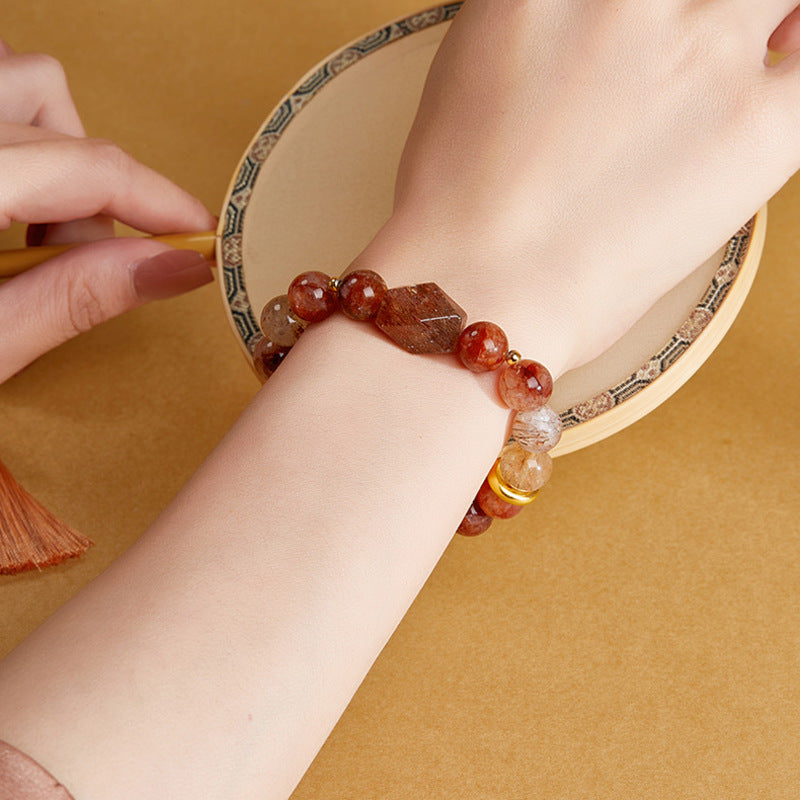 Supplier model wearing the crystal bracelet beside an embroidered handheld fan