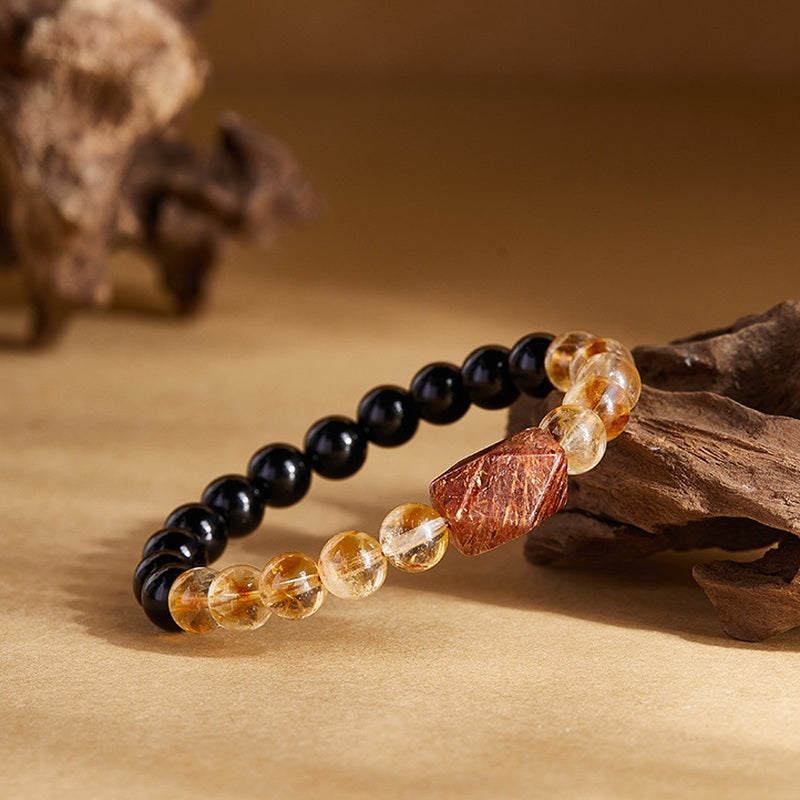Crystal bead bracelet with obsidian and golden quartz angled view