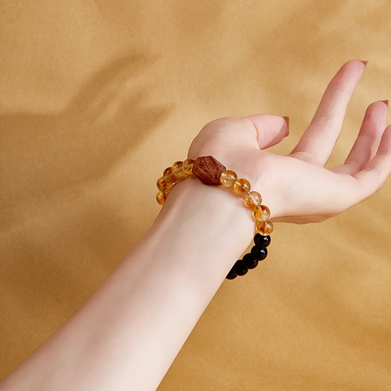 Model wearing elastic obsidian and yellow tower quartz bracelet