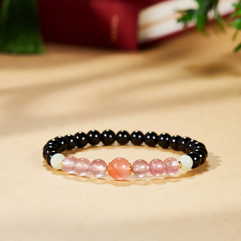 Hero image of black obsidian and South Red agate stretch bracelet