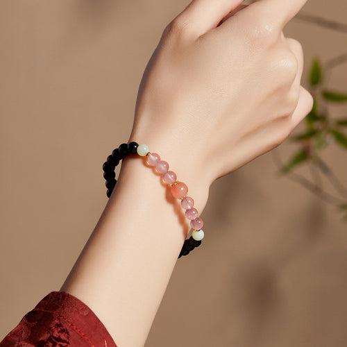 Supplier model wearing black obsidian and South Red agate stretch bracelet