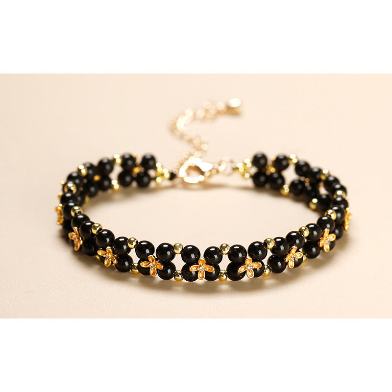 Adjustable black obsidian clover bracelet with gold-tone accents