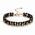 Black obsidian clover bracelet on a clean white background