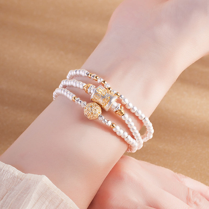 Close wrist view of 999 silver auspicious barrel bracelet