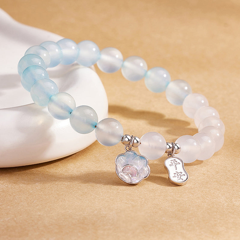 Angled detail of cat paw and safety plaque charms