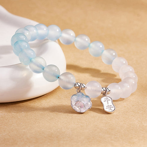 Angled detail of cat paw and safety plaque charms