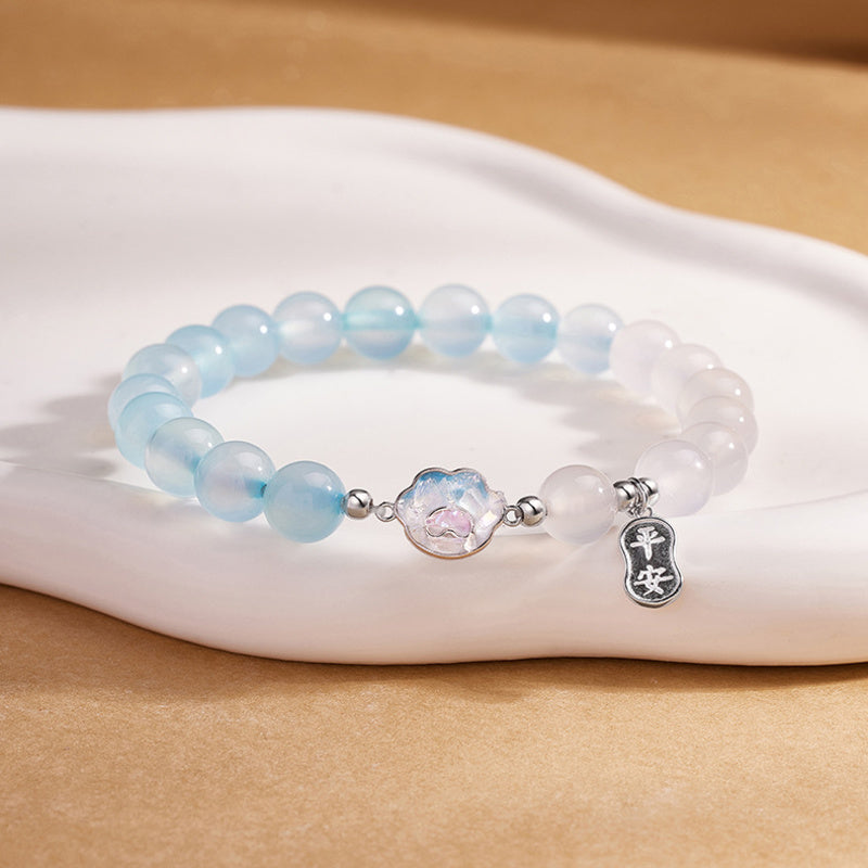 Cat paw bracelet displayed on a white ceramic plate