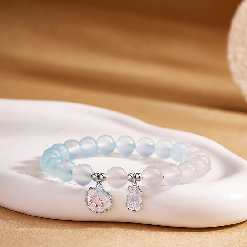 Blue agate and white chalcedony cat paw bracelet on warm display