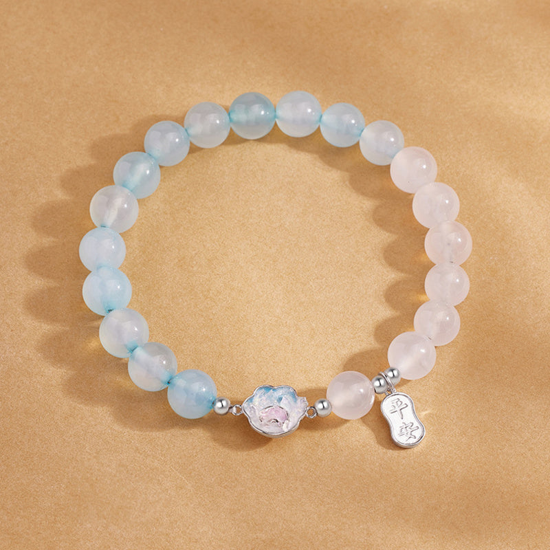 Blue agate cat paw bracelet on a warm gold backdrop