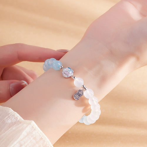Model wearing a pale blue agate cat paw bracelet