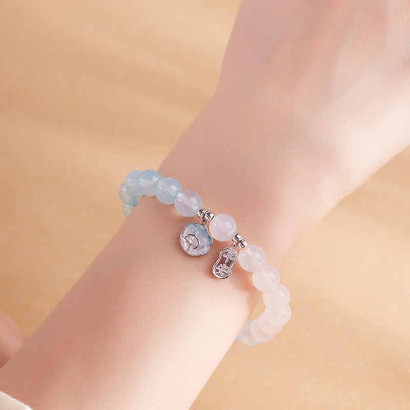 Wrist detail of pale blue agate and white chalcedony bracelet