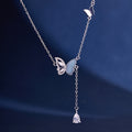 Blue enamel butterfly silver necklace with a clear teardrop against navy fabric