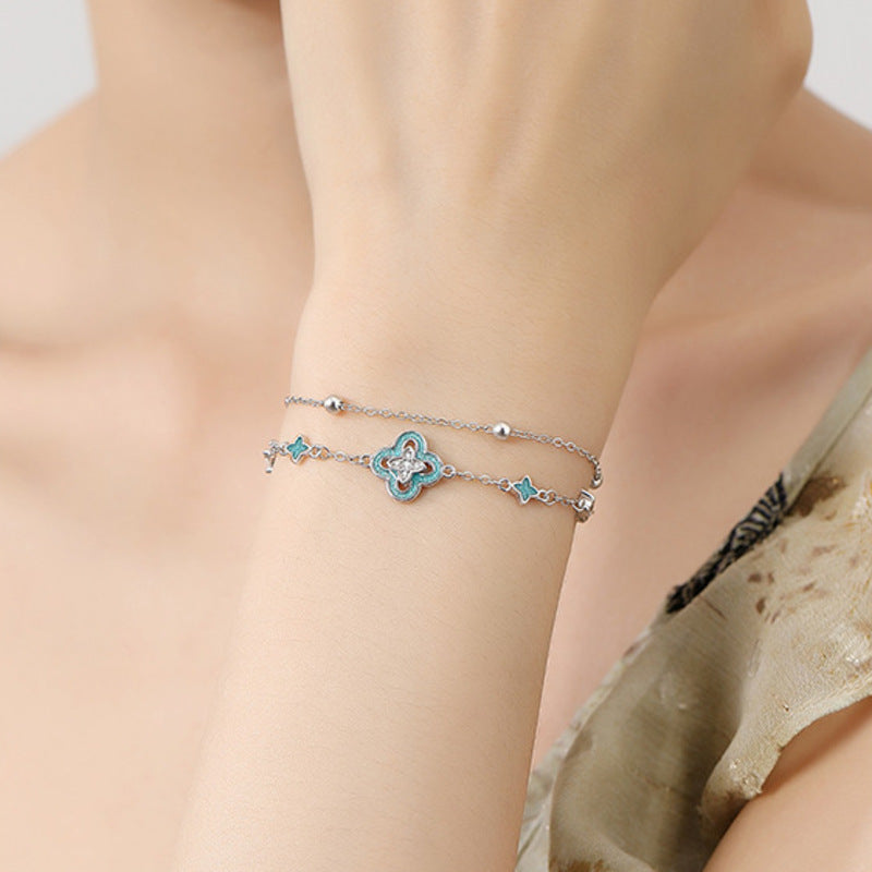 Supplier model wearing the blue enamel clover bracelet
