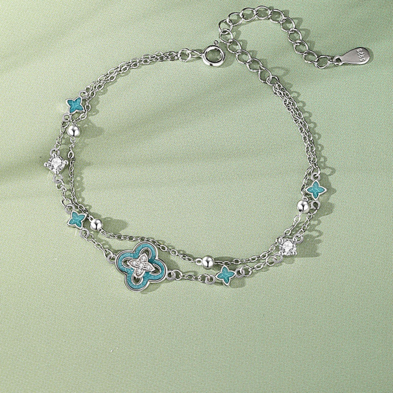 Overhead view of clover bracelet with clasp and extension chain