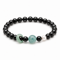 Blue water jade and obsidian bracelet on a clean white background