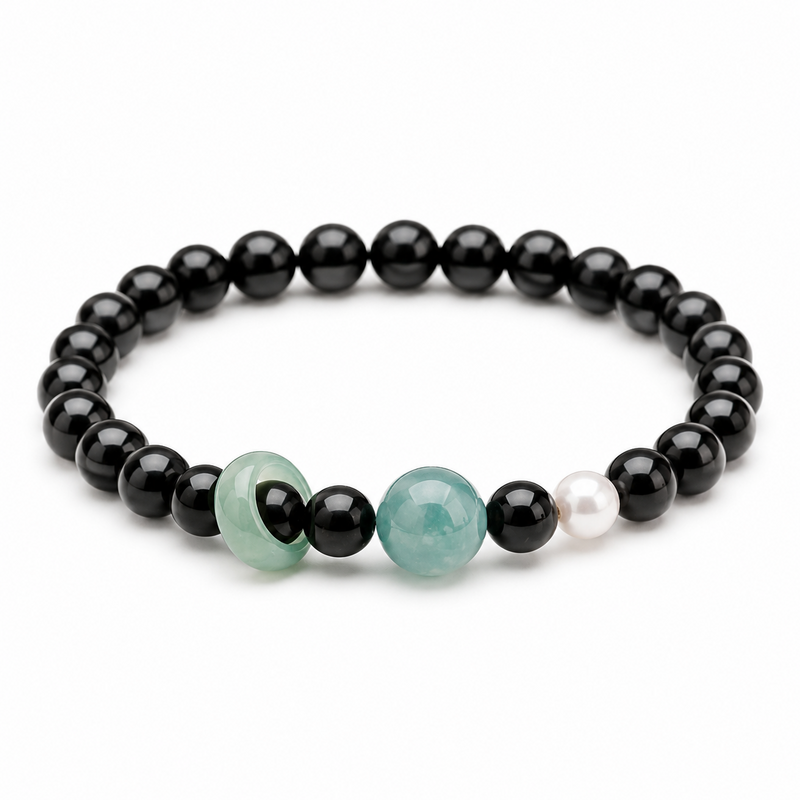 Blue water jade and obsidian bracelet on a clean white background