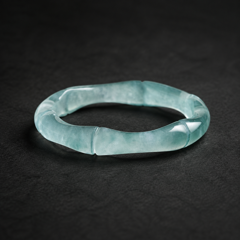 Blue water jadeite bamboo ring on dark stone
