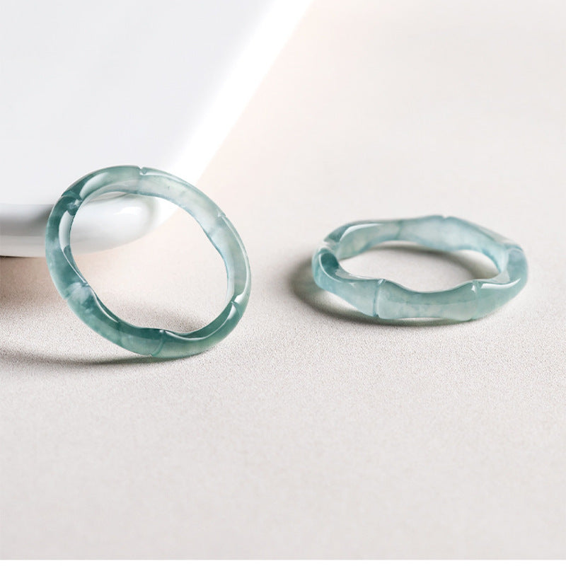 Two blue water jadeite bamboo rings in studio light