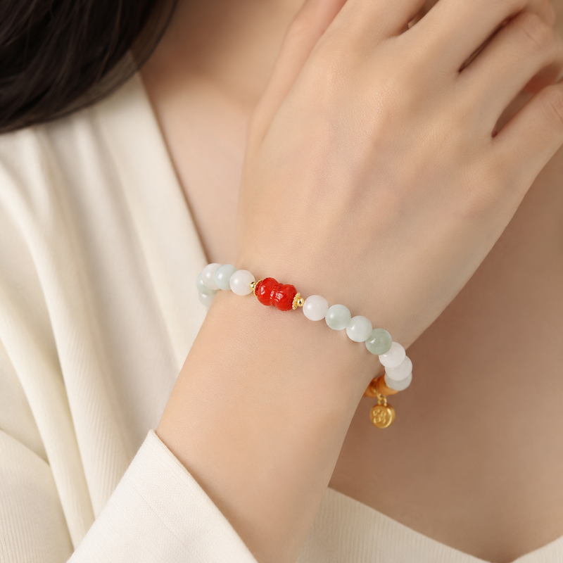 Woman wearing cinnabar twin lotus jade bracelet
