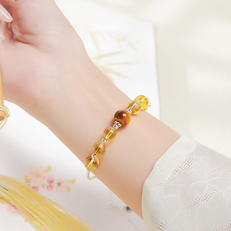 Citrine and tiger's eye bracelet worn on a wrist