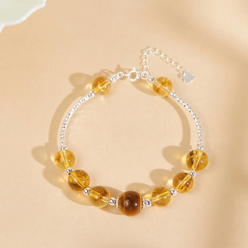Overhead view of citrine and tiger's eye bracelet with extension chain