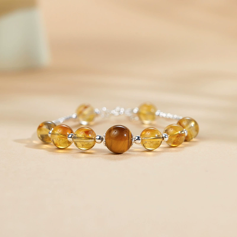 Citrine and tiger's eye bracelet with 925 silver on a warm beige background
