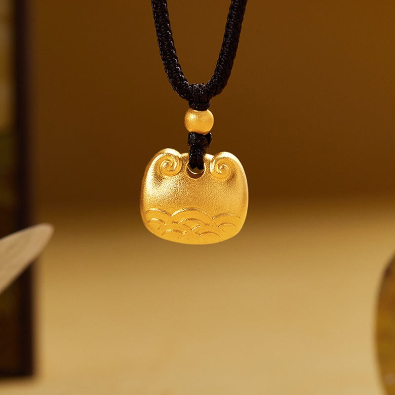 Gold-tone 999 fine silver cloud peace lock pendant against a warm gold background