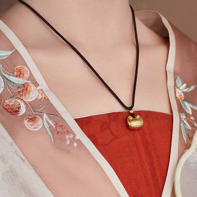Original model wearing the peace lock necklace from an angle
