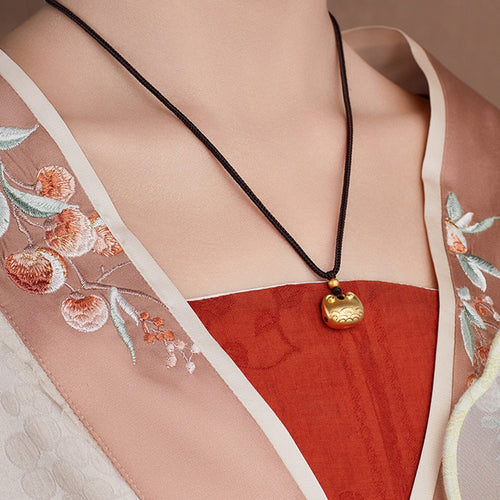 Original model wearing the peace lock necklace from an angle