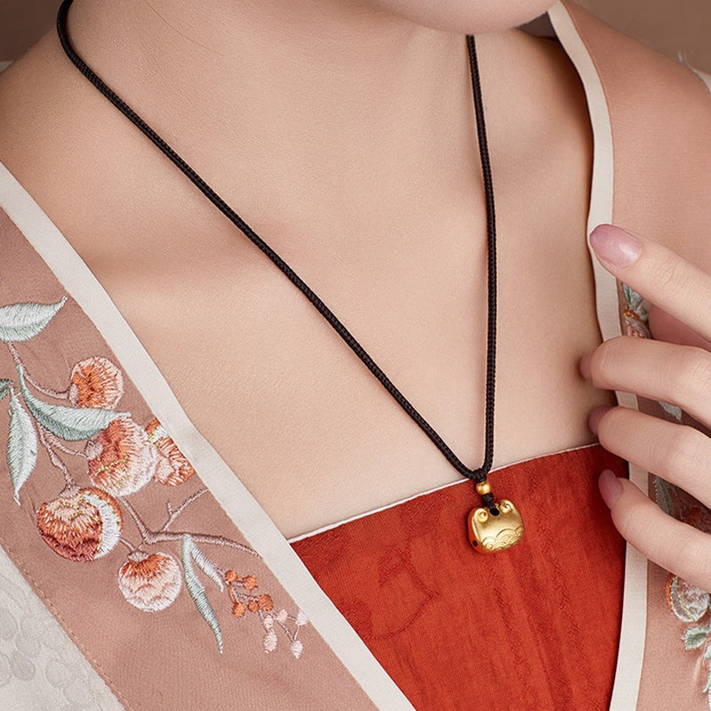 Original model wearing the peace lock necklace with embroidered clothing