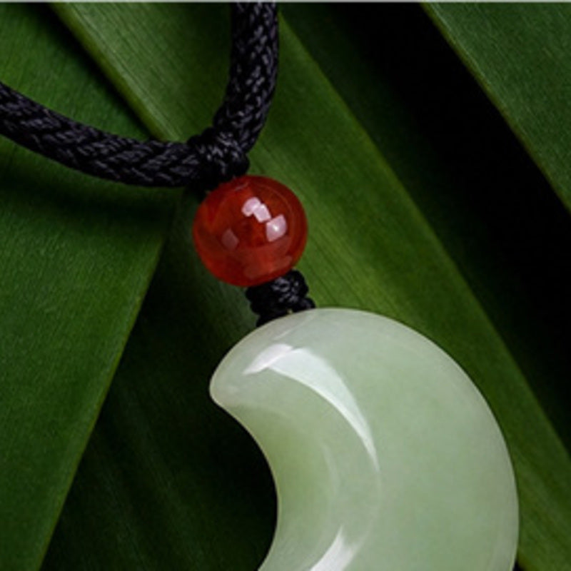 Black waxed cord and red carnelian detail on crescent moon necklace