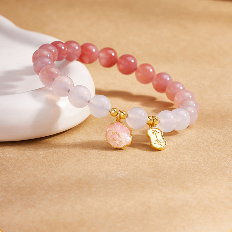 Crimson agate bracelet angled view with cat paw charm