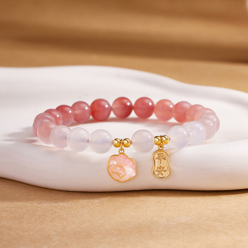 Crimson agate cat paw bracelet on warm silk display