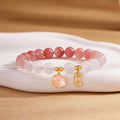 Crimson agate cat paw bracelet on warm silk display