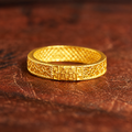 Double Happiness filigree ring on a warm wooden background
