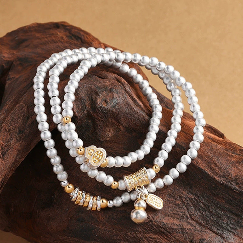 Close view of Fine Silver 999 gourd triple-wrap bracelet