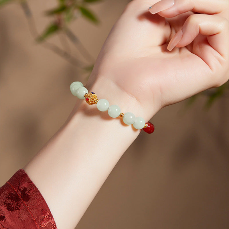 Supplier model wearing red agate and nephrite jade fortune bead bracelet