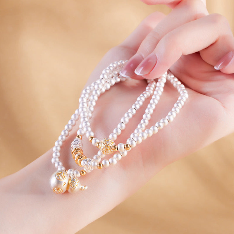 Model holding 999 fine silver gourd multi-wrap bracelet