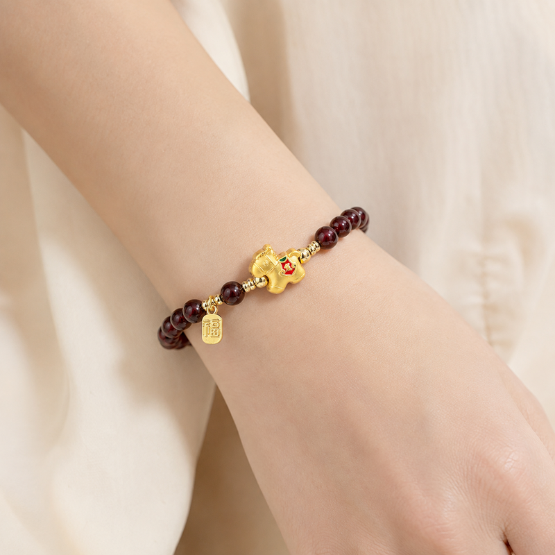Woman wearing a garnet lucky horse bracelet
