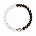 Gold obsidian and aquamarine blue crystal gourd bracelet on white background