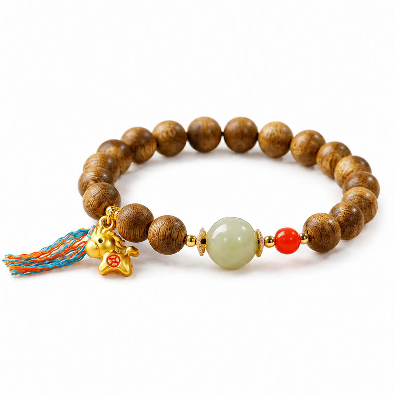 Gold-tone lucky horse Qinan agarwood bracelet on white background