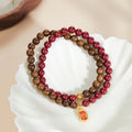 Golden Radiance cinnabar and sandalwood bracelet on shell