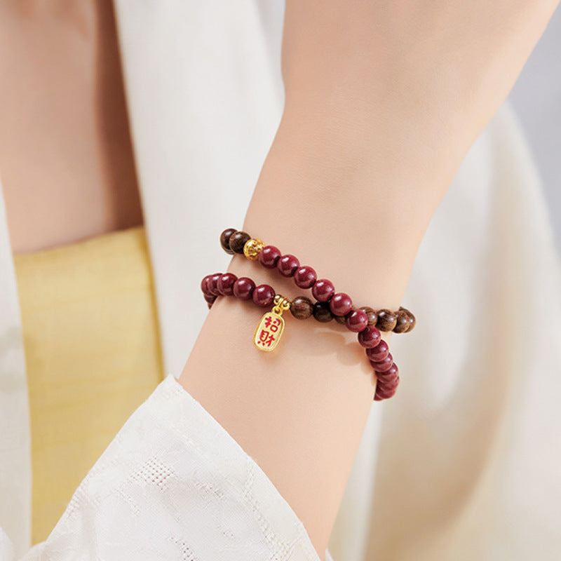 Cinnabar and sandalwood bracelet close wrist view