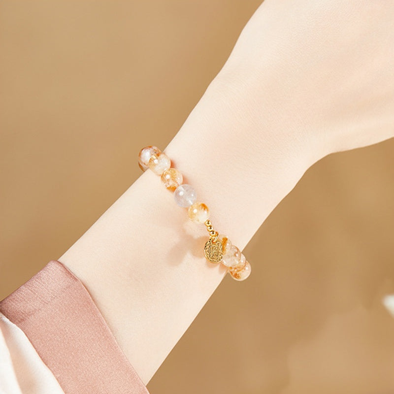 Original supplier photograph of yellow quartz blessing bracelet worn on wrist