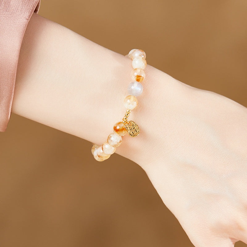 Original supplier photograph of yellow quartz blessing bracelet worn on wrist